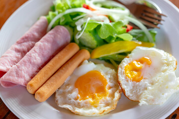 fried eggs with bacon, sausages and toasts
