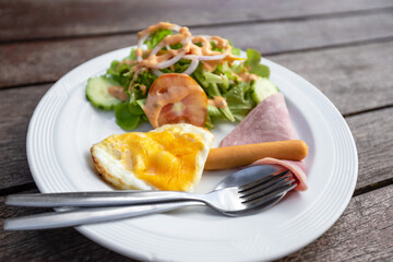 fried eggs with bacon, sausages and toasts