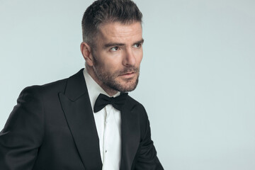 businessman in his mid age wearing a black tuxedo