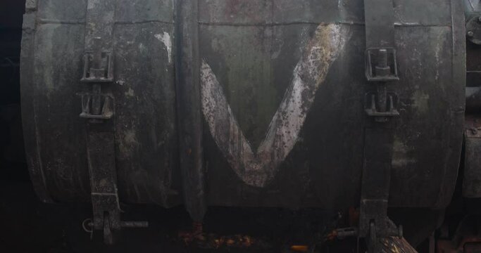 Close-up detailed tracking shot of the armor of a burnt-out Russian tank t-72. Exibition in Kyiv on Sophia Square Letter V on the tank.