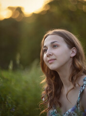 Naklejka premium Photo of a beautiful girl in a summer meadow.