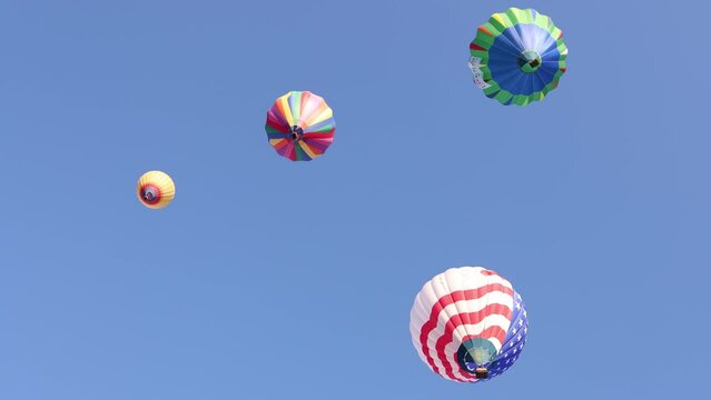 Hot Air Balloons Flying High in the Clear Blue Sky in Reno Nevada.  Shallow Depth of Field.