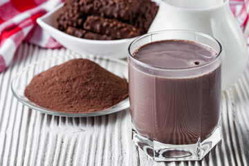 chocolate cocoa milk powder on a white wooden rustic background