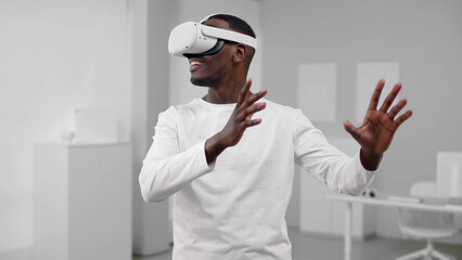 Portrait of African-American man in white clothes use augmented reality headset 