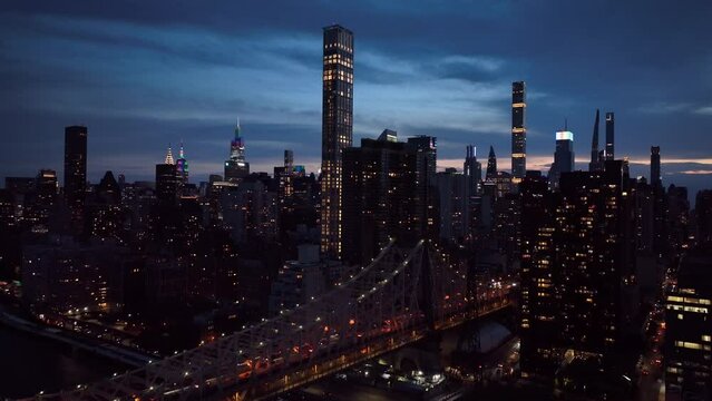 dusk view of NYC skyline descending next to Ed Koch Queensboro Bridge