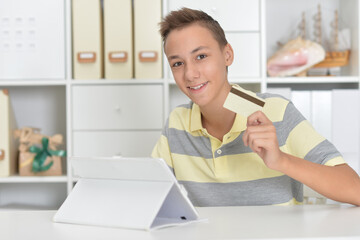 Portrait of boy with the tablet shopping online