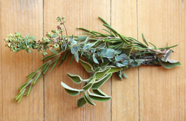 fresh Mediterranean herbs on wooden background