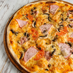 delicious hot traditional italian pizza on a white wooden rustic background