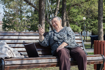 Fototapeta premium Portrait of smiling senior womane njoying pleasant conversation on mobile phone