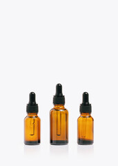 Natural medicine or essential aroma oil or beauty essence concept three vials bottle with dropper...