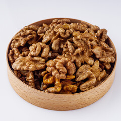 dried walnuts on a white acrylic background