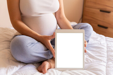 Pregnancy mockup digital tablet. Pregnant woman holding smart tablet. Mobile pregnancy online...