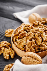 dried walnuts on a black rustic wooden background