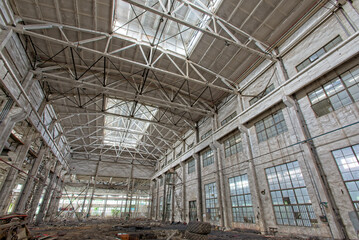 Interior of abandoned steel frame workshop factory building in industrial area