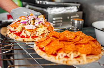 hand of chef baker making mini pizza at kitchen. The process of making pita pizza. cooking italian pizza