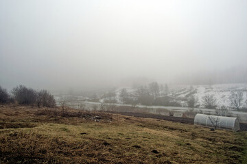 plastic greenhouse on the bank of the river