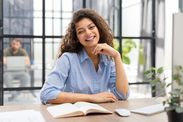 Smiling businesswoman looking at camera, make conference or business call, recording video blog, talking with client.