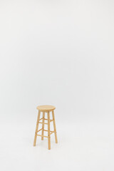 wooden chair on a white wall
