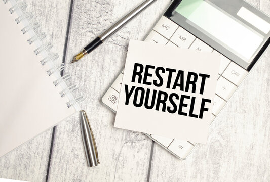 RESTART YOURSELF text on sticker with calculator, glasses and magnifier