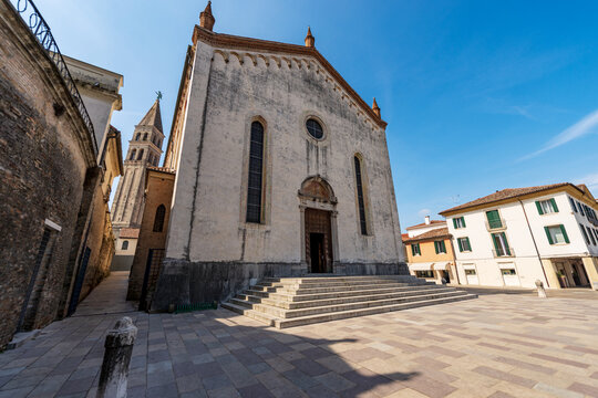 Facade of Oderzo Cathedral, Saint John Baptist (Duomo di San Giovanni Battista) with the leaning bell tower, XIII century. Square called Campiello del Duomo, Treviso province, Veneto, Italy, Europe.