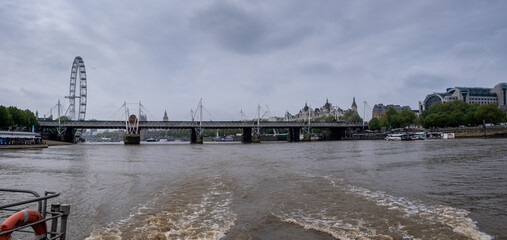 Large panoramic view of Hungerford & Golden Jubilee Bridges and the London Eye from Thames river,...