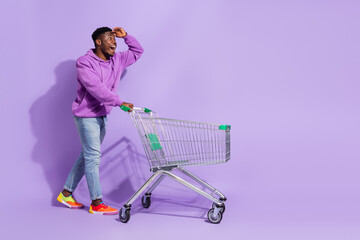 Full body profile photo of excited astonished man hand forehead look empty space isolated on purple...