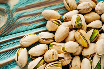fresh salted pistachios on a wooden rustic background