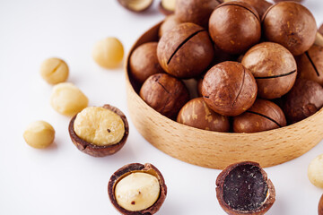 fresh macadamia nuts on a white acrylic background