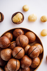 fresh macadamia nuts on a white acrylic background