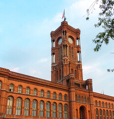View of Rotes Rathaus in summer, the famous red town hall of Berlin with clouds in blue sky background.