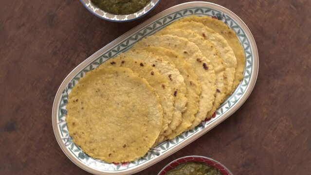 Mixed leaves dish (Sarson ka saag) with corn bread (Makki di roti). Homemade food meal. Authentic Punjabi cuisine.