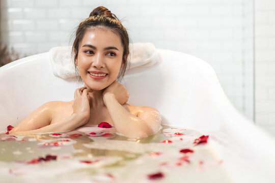 Portrait of smiling of happy beauty pretty asian woman clean fresh healthy white skin spa treatment enjoy relaxing taking shower and bath with bubble foam spa in bathtub at bathroom