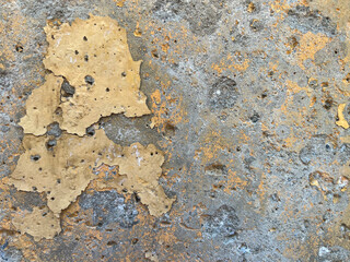 Old cracked weathered plaster concrete wall texture, Old dirty flaky indented concrete wall with destroyed plaster, damaged yellow painting, grunge surface texture background