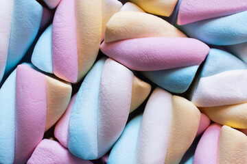 Close up view of colorful marshmallows isolated on black.