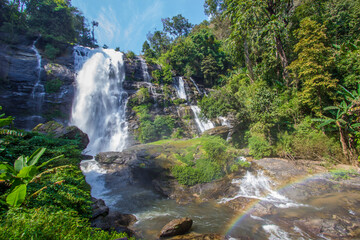 Fototapeta na wymiar Strong flow with rain-like mist and rainbow in the spray of Vachirathan Waterfall in Doi Inthanon National Park,Chom Thong District,Chiang Mai province,Northern Thailand.