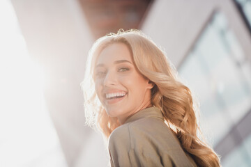 Profile side view portrait of attractive cheerful wavy haired girl enjoying traveling summertime having fun in town outdoors