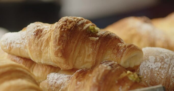 Close-up of golden croissants in a bakery. Tipical breakfast with croissant and coffee, food conception