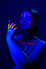 Girl with fluorescent make up on her face and chest