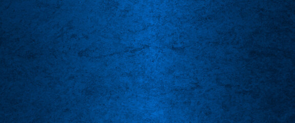 Blue abstract lava stone texture background, dark blue rough grainy stone or concrete wall texture background, Blue background with faint texture and bright center and black vignette border.
