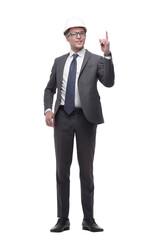 serious businesswoman in helmet pointing up . isolated on white