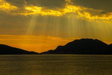 stormy sky over the sea , the rays of the sun break through the clouds