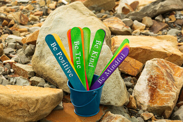 Motivational and inspirational quote written on a colorful wooden stick.