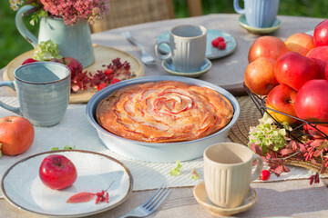 apple pie on laid table in  garden on sunny day