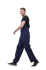 smiling man in overalls goes forward.isolated on white