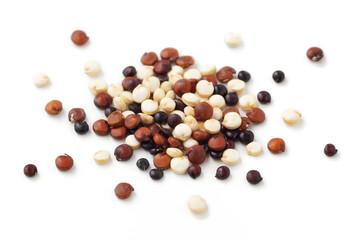 Pile of mixed quinoa closeup isolated on white background