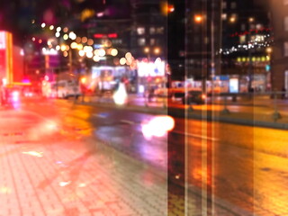 Fototapeta na wymiar city night light street reflection car traffic buildings blurred light red yellow bokeh vew from window urban holiday lifestyle