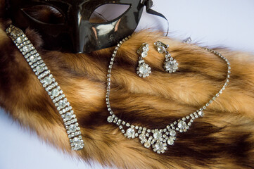 Antique crystal glass jewelry set on fur with a mask