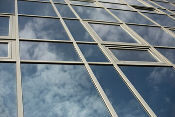 Building is made of glass. Mirror surface in office building.