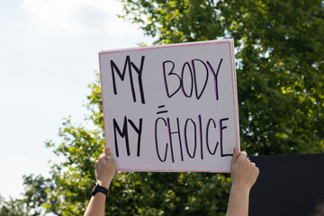 Woman's hands holding a sign that says "My Body My Choice" during an abortion rights rally.