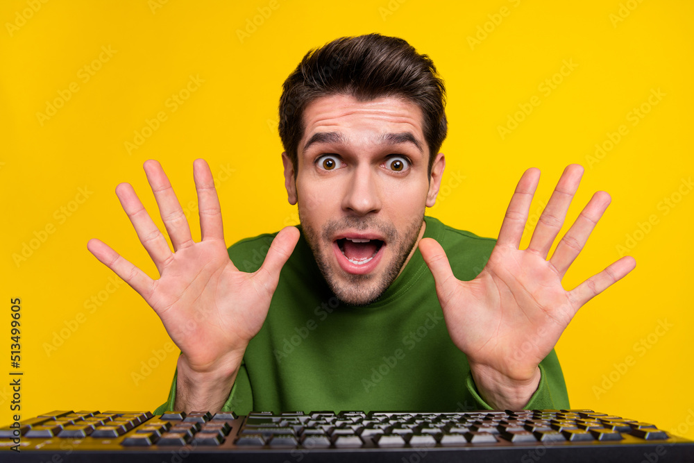 Aufkleber portrait of attractive funny amazed guy nerd using laptop having fun isolated over vibrant yellow co